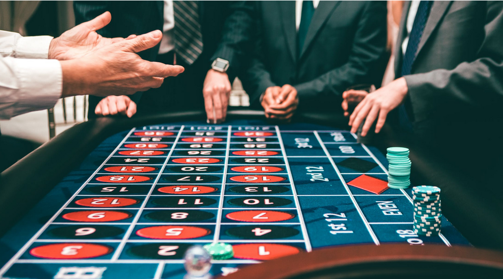men gambling on a casino table